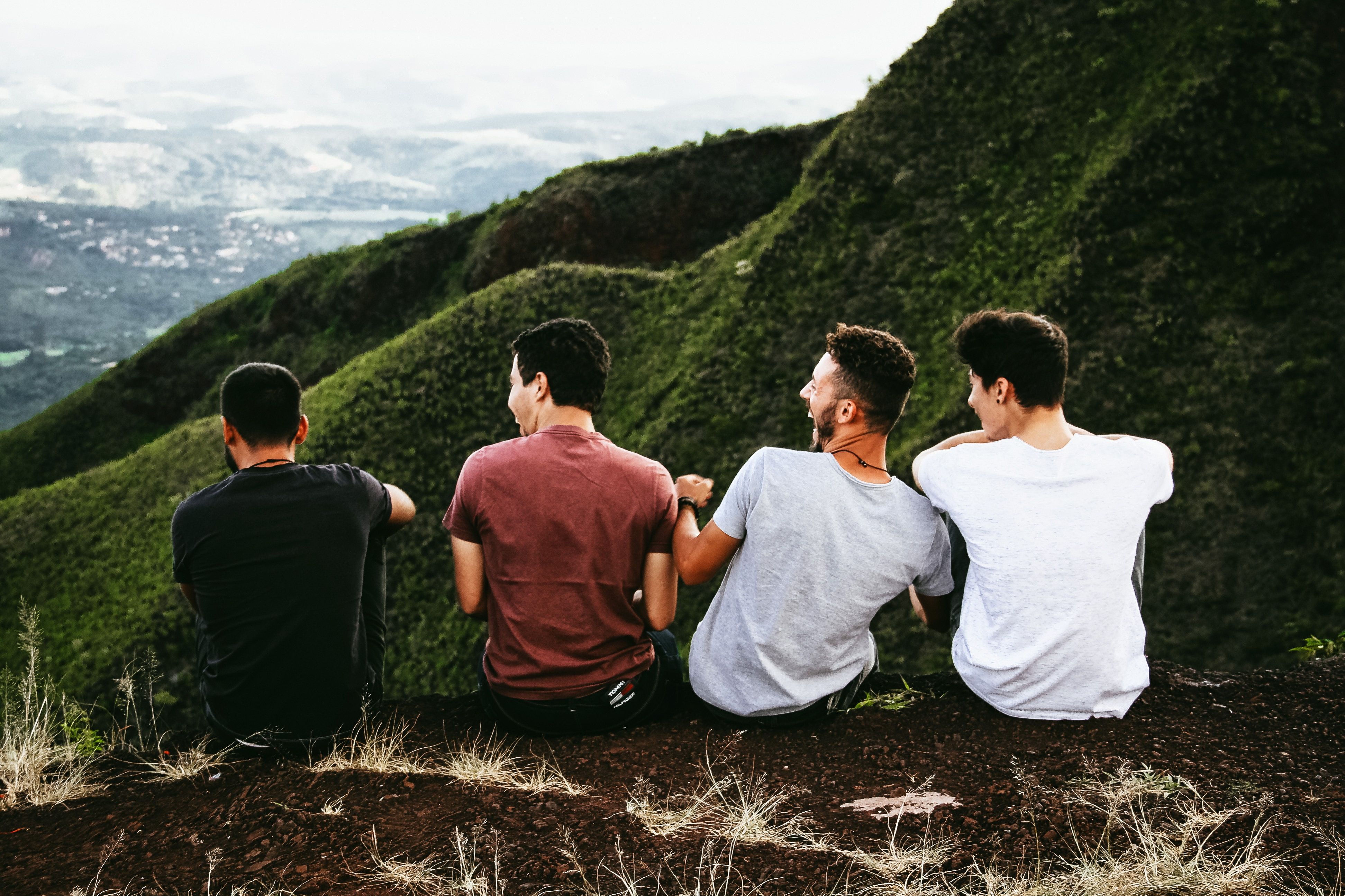 Four guys sat laughing together.