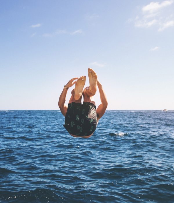 A guy jumping into the sea.