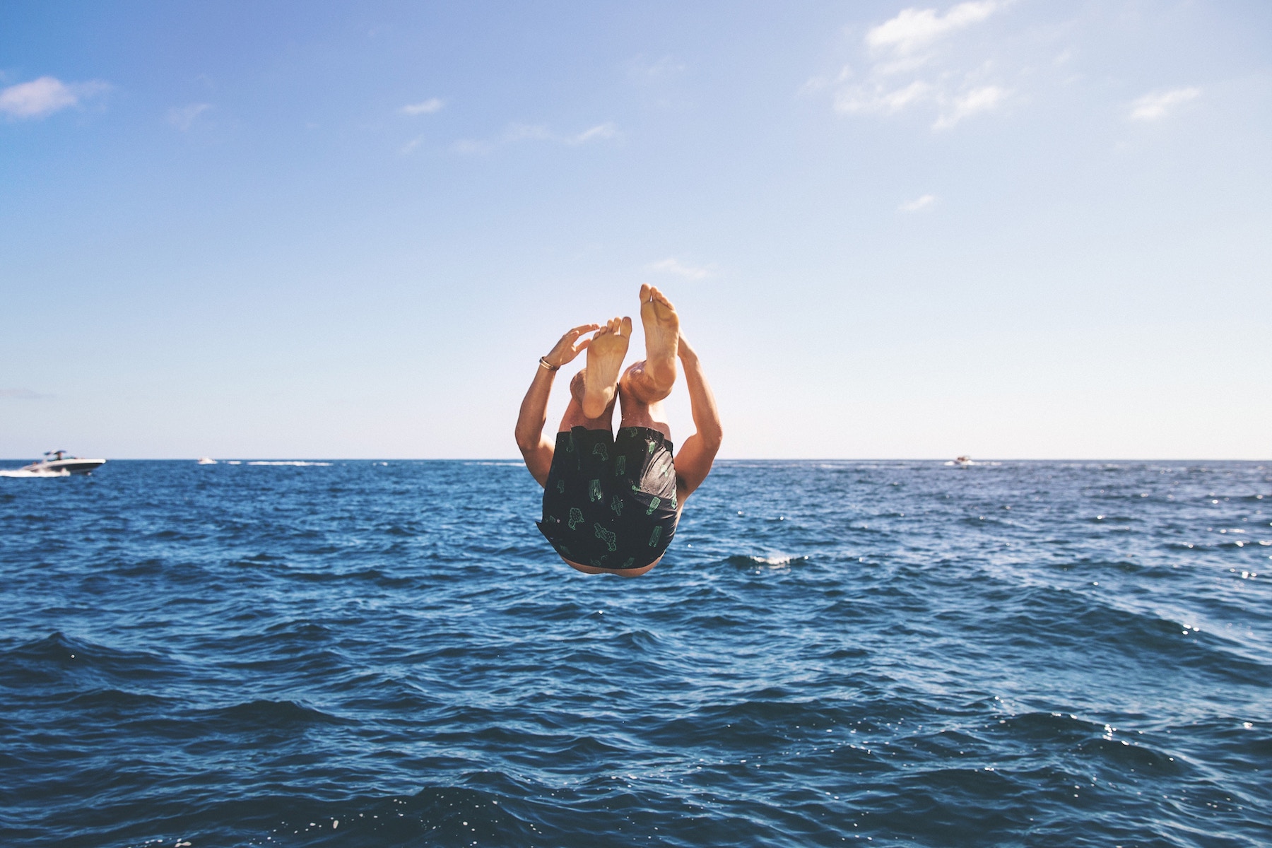 A guy jumping into the sea.