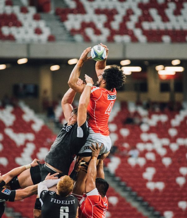 Two teams attempt to catch a rugby ball in a lineout.