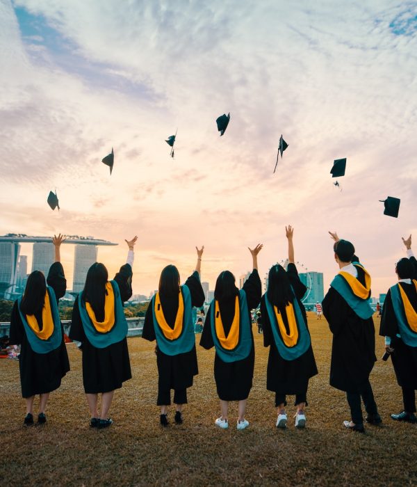 A group of people graduating and throwing their caps in the air.