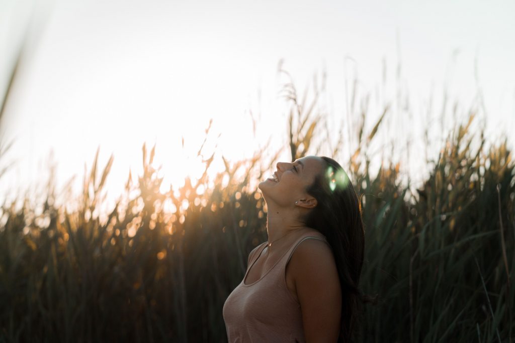 lady, girl, looking upwards, laughing, field, grass, sunset