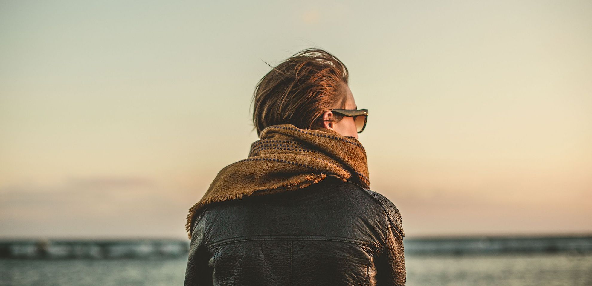 looking into the distance, sunglasses, scarf, leather jacket